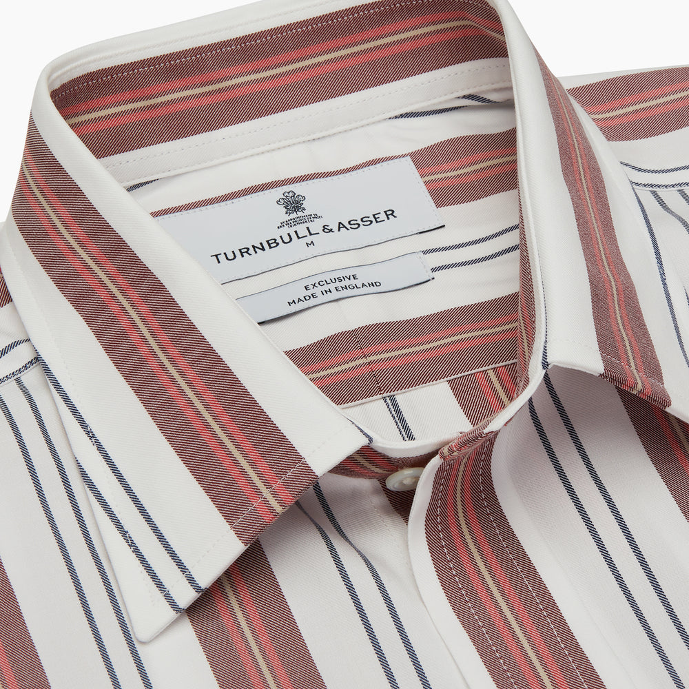 The Turnbull & Asser Red, Blue & White Stripe Weekend Fit Shirt features a Derby collar, 1-button cuffs, and crisp stripes—ideal for stylish winter layering.