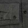 View 4 of product The Charcoal Melange Hampstead overshirt by Turnbull & Asser is a dark gray long-sleeve button-up with a collar, left chest pocket, and two zippered side pockets, shown laid flat on a white background.