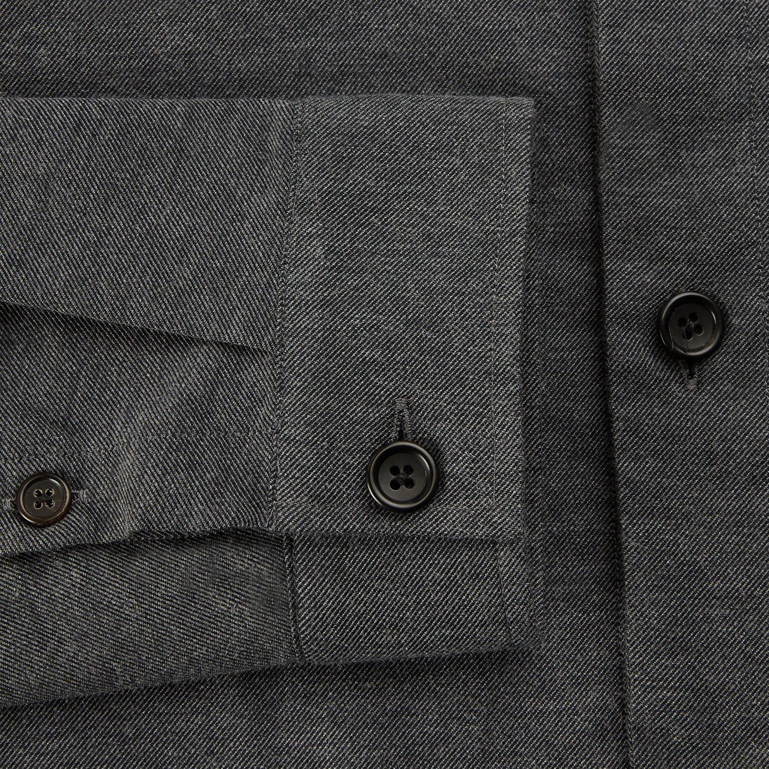 View 4 of product The Charcoal Melange Hampstead overshirt by Turnbull & Asser is a dark gray long-sleeve button-up with a collar, left chest pocket, and two zippered side pockets, shown laid flat on a white background.