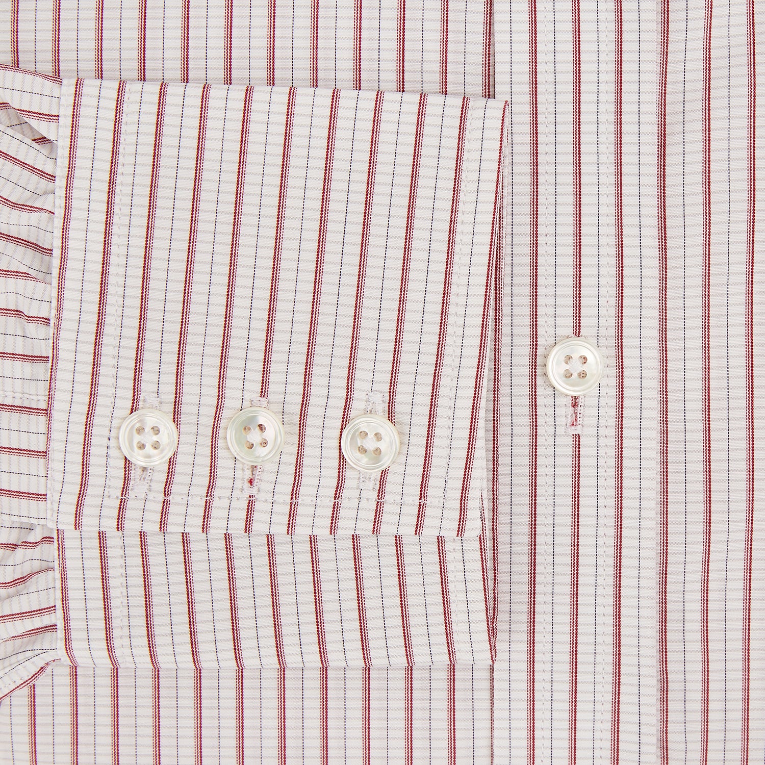 View 4 of product The Turnbull & Asser Red Graph Check Mayfair Shirt features a classic collar and buttoned cuffs, with red and blue stripes on white, ideal for formal wear. Laid flat on a white surface.