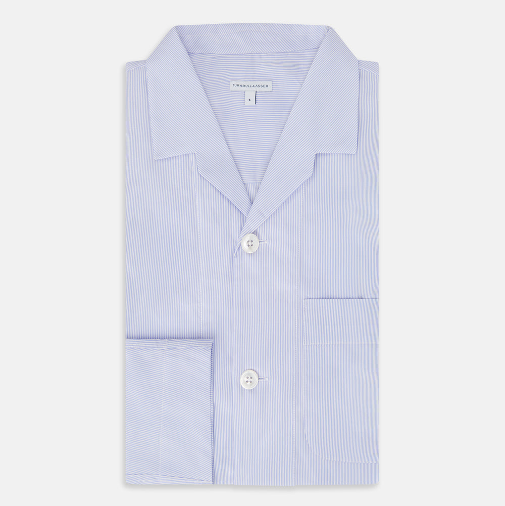 The Turnbull & Asser Pale Blue Hairline Stripe Pyjama Shirt features long sleeves and a single chest pocket, offering an elegant sleepwear style—shown on a plain white background.