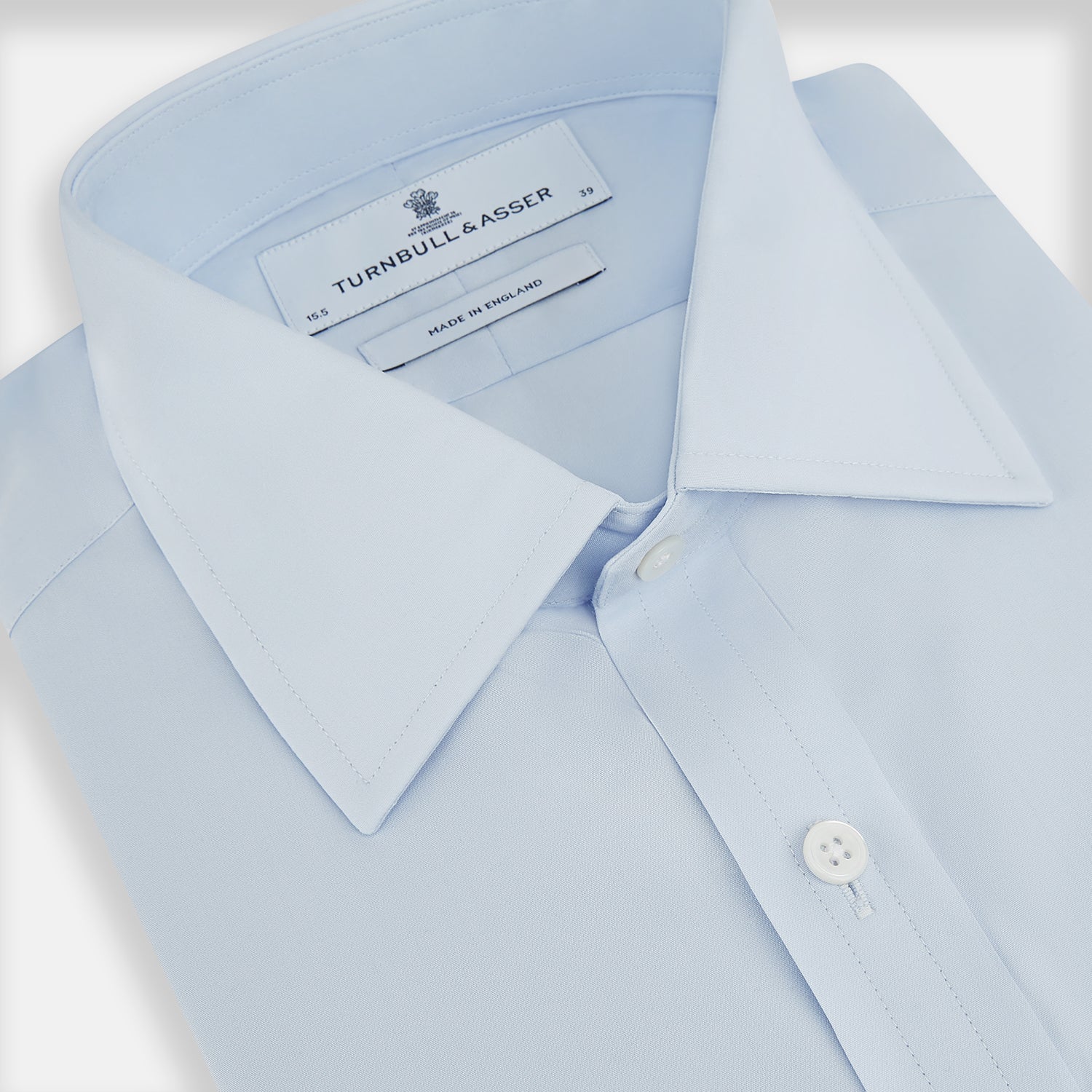 View 2 of product The Turnbull & Asser PALE BLUE COTTON REGULAR FIT MAYFAIR SHIRT is a long-sleeve, button-down shirt with a pointed T&A collar, shown laid flat on a white background.
