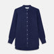 The Turnbull & Asser Blue Soft-touch Silk Lauren Shirt is a navy, long-sleeve button-up with an Igret stand collar, white buttons, curved hem, relaxed fit, and elongated body for a modern look, shown laid flat on a white background.