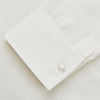 View 3 of product The Cream Silk Long Point Embroidered Eamon Shirt by Turnbull & Asser features long sleeves, a pointed collar, and delicate botanical embroidery. Its buttoned cuffs and tailored fit make it an elegant partywear choice.