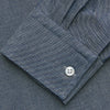 View 3 of product The Turnbull & Asser Plain Blue Oxford Cotton Weekend Fit Blake Shirt features long sleeves, a stand collar, and white buttons, displayed flat on a white background.
