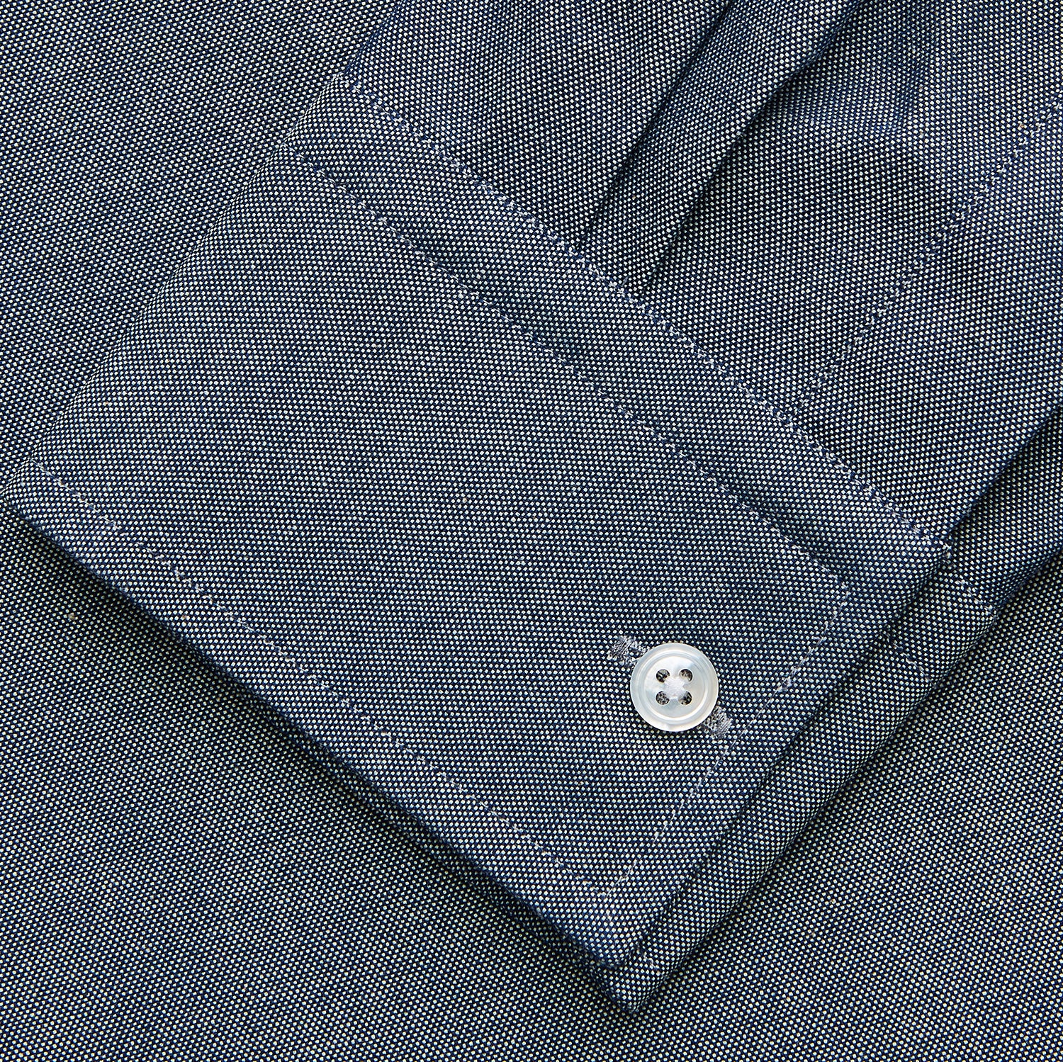 View 3 of product The Turnbull & Asser Plain Blue Oxford Cotton Weekend Fit Blake Shirt features long sleeves, a stand collar, and white buttons, displayed flat on a white background.