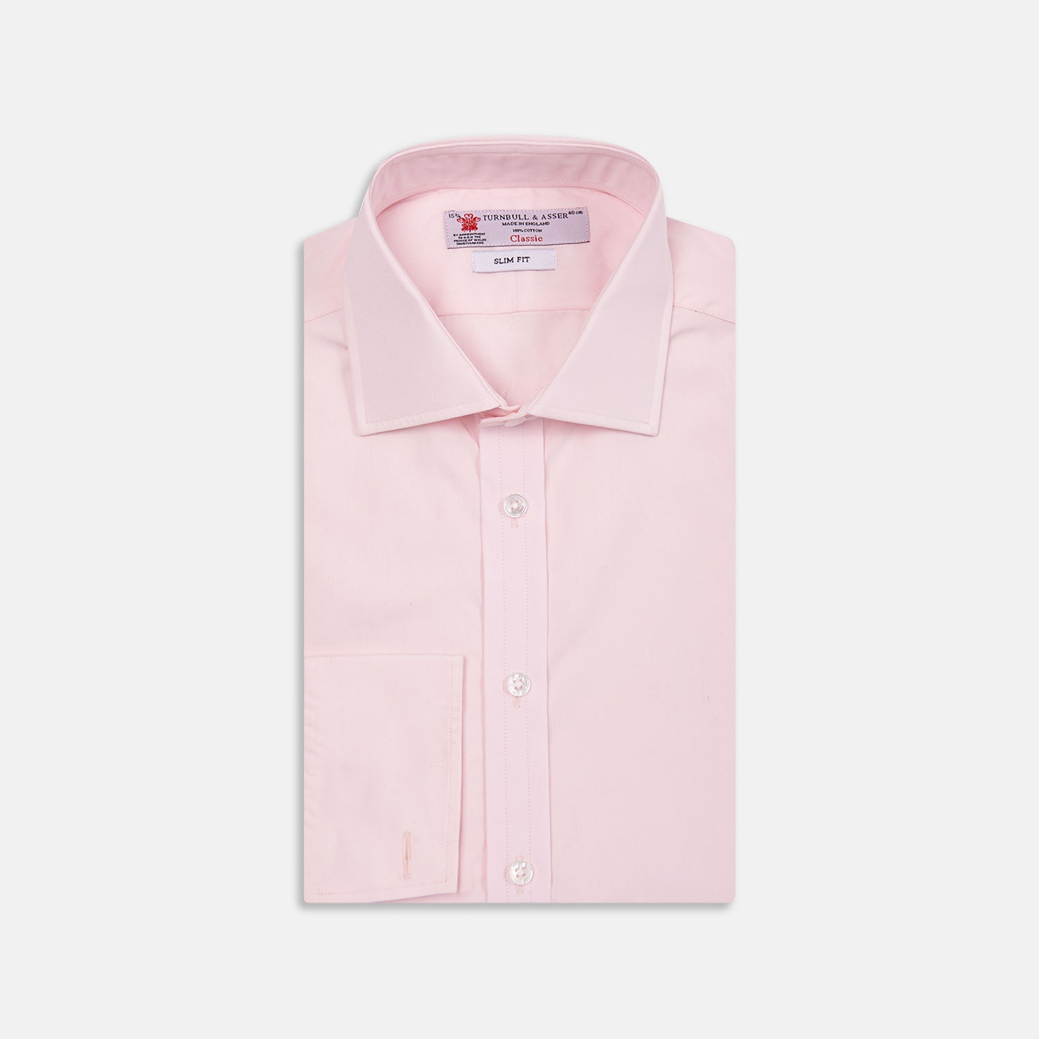 View 1 of product The Turnbull & Asser Pink Poplin Slim Fit Regent Collar Shirt features white buttons and a slim fit label, neatly folded and displayed on a plain white background.