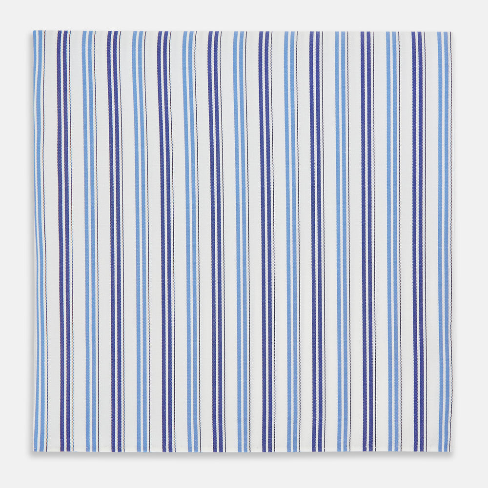The Blue and Navy Multi Stripe Hand-Rolled Handkerchief by Turnbull & Asser is crafted in England with a white background and evenly spaced vertical stripes in blue and navy.