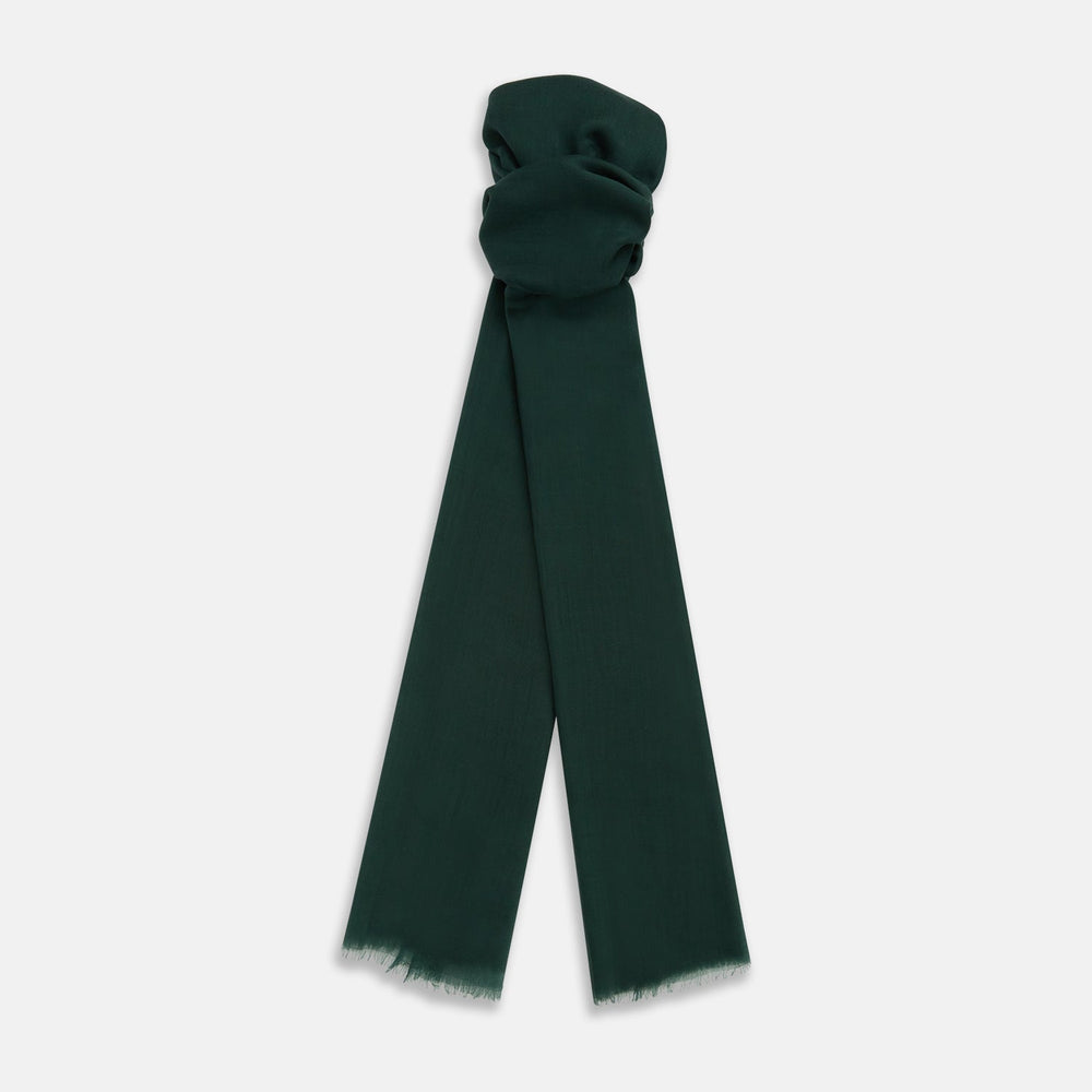 The Turnbull & Asser Forest Green Cashmere Scarf features a hand-dyed finish, soft texture, and lightly frayed edges, artfully tied in a loose knot and displayed on a white background—a true luxury accessory.