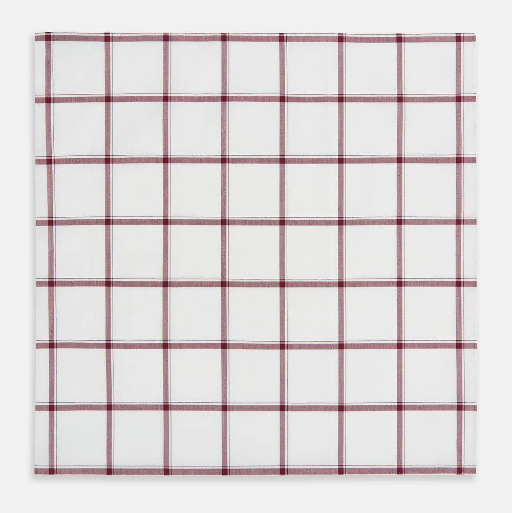 The Turnbull & Asser Burgundy Grid Check Hand-Rolled Handkerchief features a white base with burgundy grid lines forming large squares and is finished with elegant hand-rolled edges.