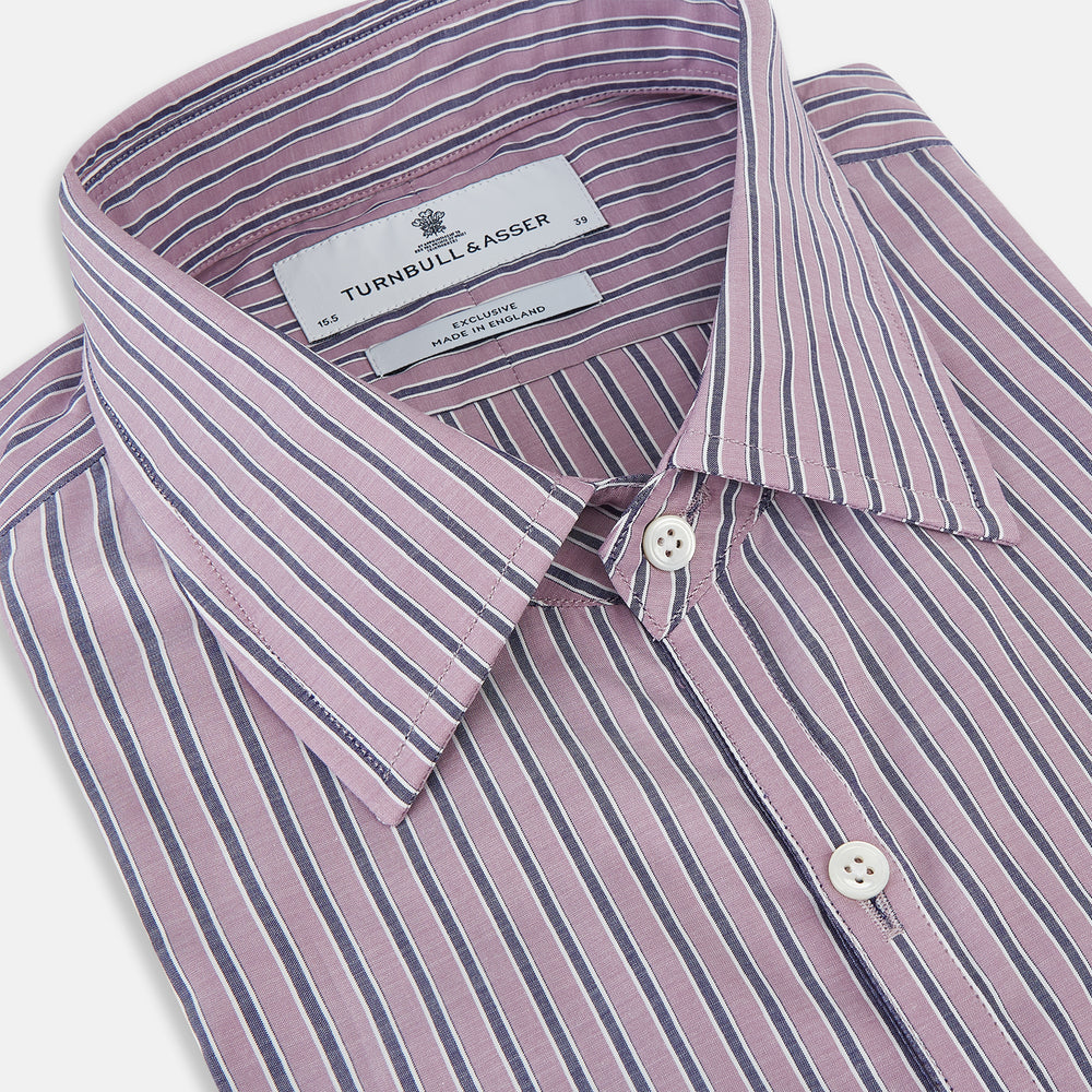 The Turnbull & Asser Antique Pink Ticking Stripe Westminster Shirt is a collared, long-sleeve button-up with thin vertical pink stripes on white, highlighting British craftsmanship. It’s shown neatly laid flat and fully buttoned.