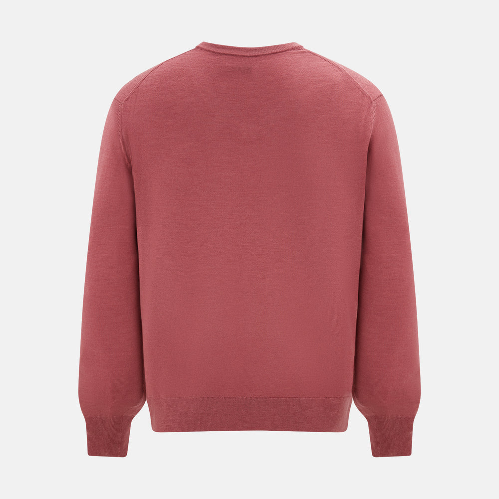 The Turnbull & Asser Antique Pink Merino V-Neck Jumper features ribbed cuffs, hem, and neckline in a soft antique pink, shown on a plain white background. Part of our knitwear collection.