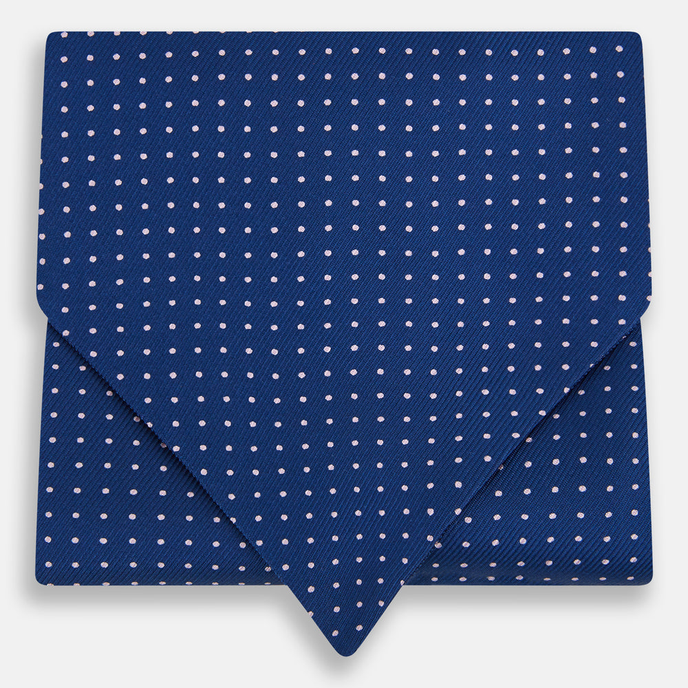 The Turnbull & Asser Pink Dot and Royal Blue Silk Cravat is an elegant British-style wedding accessory, neatly folded with a pointed edge and finished with pink dots, perfect for complementing formal attire.