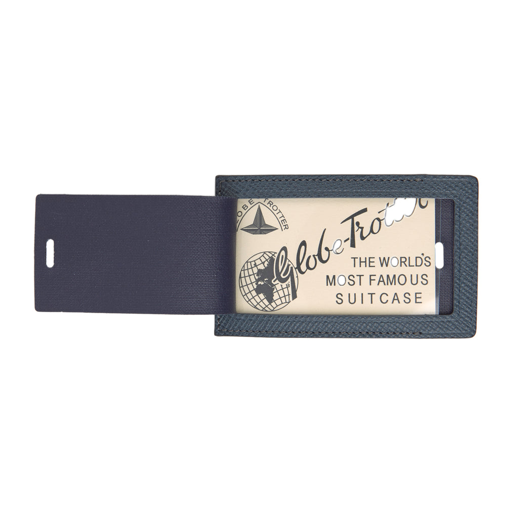 The Blue Leather Luggage Tag by Turnbull & Asser features textured leather, a metal buckle and strap, and displays the logo with "Made in England" printed in white at the bottom.