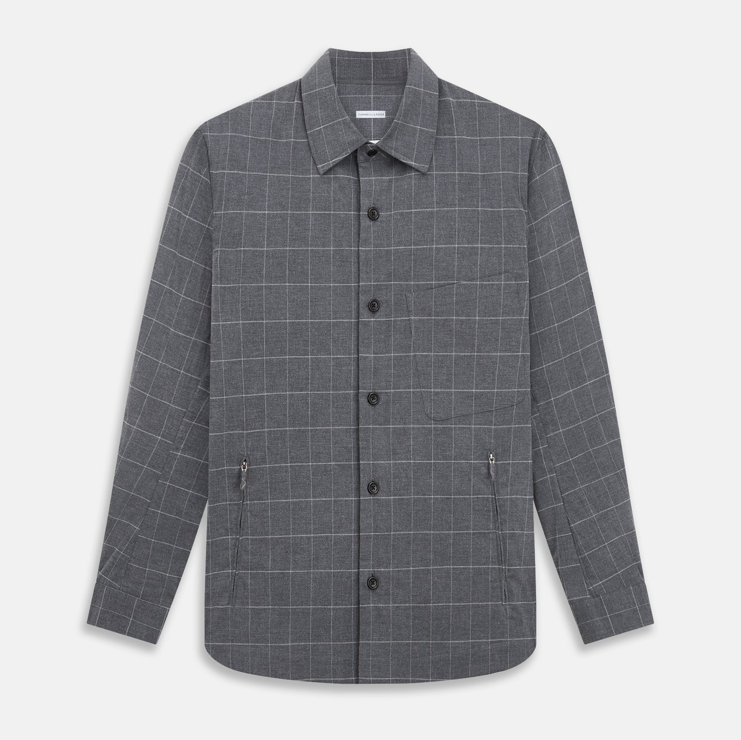 View 1 of product The Turnbull & Asser Charcoal Melange Check Hampstead overshirt, a long-sleeve button-up with a collar and two zippered side pockets, is laid flat on a light gray background.