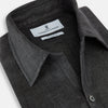 View 2 of product The Ash Linen Windsor Shirt by Turnbull & Asser is a long-sleeve, button-up black shirt with a Windsor collar and cuffs, reflecting British craftsmanship, shown on a plain white background.