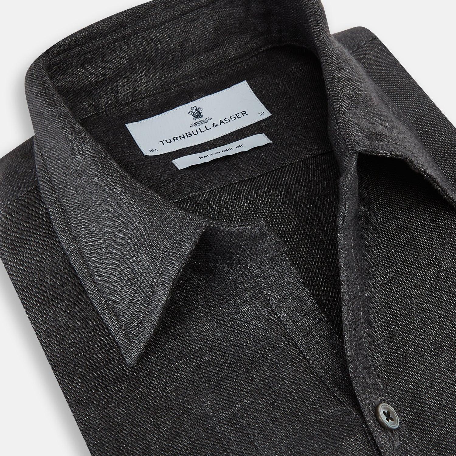 View 2 of product The Ash Linen Windsor Shirt by Turnbull & Asser is a long-sleeve, button-up black shirt with a Windsor collar and cuffs, reflecting British craftsmanship, shown on a plain white background.