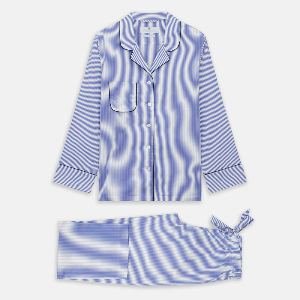 The Turnbull & Asser Women's Harriet Blue Bengal Stripe Pyjama Set features premium cotton, a long-sleeve button-up top with chest pocket, and drawstring pants—an ideal gift option.