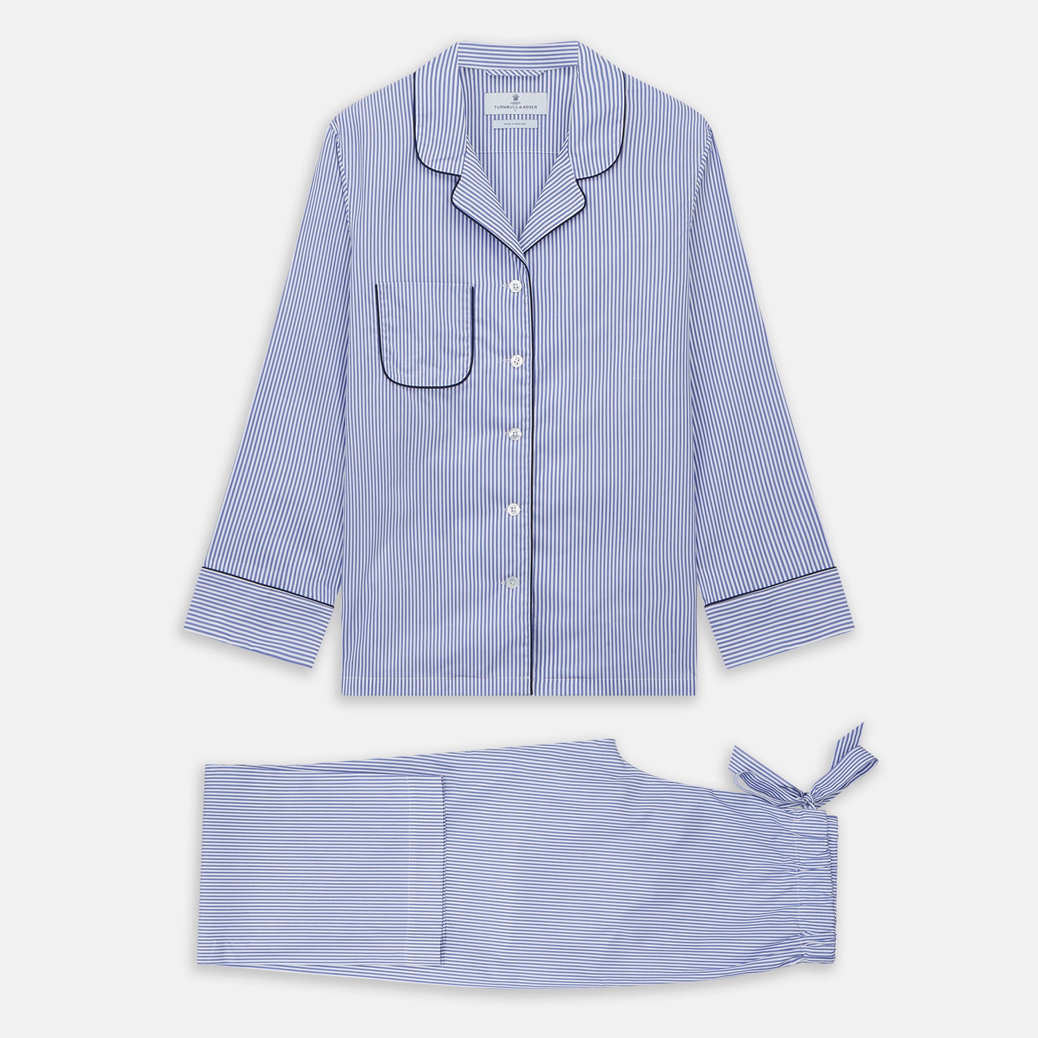 View 2 of product The Turnbull & Asser Women's Harriet Blue Bengal Stripe Pyjama Set features premium cotton, a long-sleeve button-up top with chest pocket, and drawstring pants—an ideal gift option.