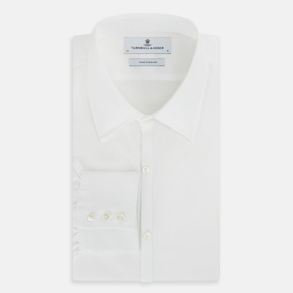 The PLAIN WHITE WESTMINSTER SHIRT WITH TURNBULL COLLAR AND 3-BUTTON CUFFS by Turnbull & Asser features refined British craftsmanship, long sleeves, a straight hem, and a crisp white design displayed on a plain background.