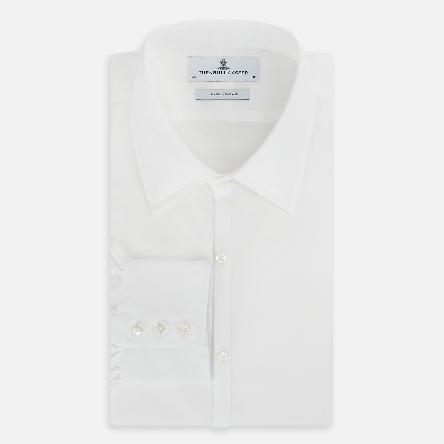 View 5 of product The PLAIN WHITE WESTMINSTER SHIRT WITH TURNBULL COLLAR AND 3-BUTTON CUFFS by Turnbull & Asser features refined British craftsmanship, long sleeves, a straight hem, and a crisp white design displayed on a plain background.