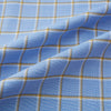 View 6 of product The Turnbull & Asser Blue and Yellow Windowpane Mayfair Shirt is crafted from fine Italian cotton, featuring a light blue base with yellow and white checks, shown on a plain white background.