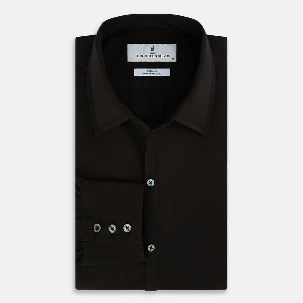 A long-sleeved, collared MIDNIGHT BLUE WINDSOR SHIRT by Turnbull & Asser, laid flat on a white background, highlights classic British craftsmanship.