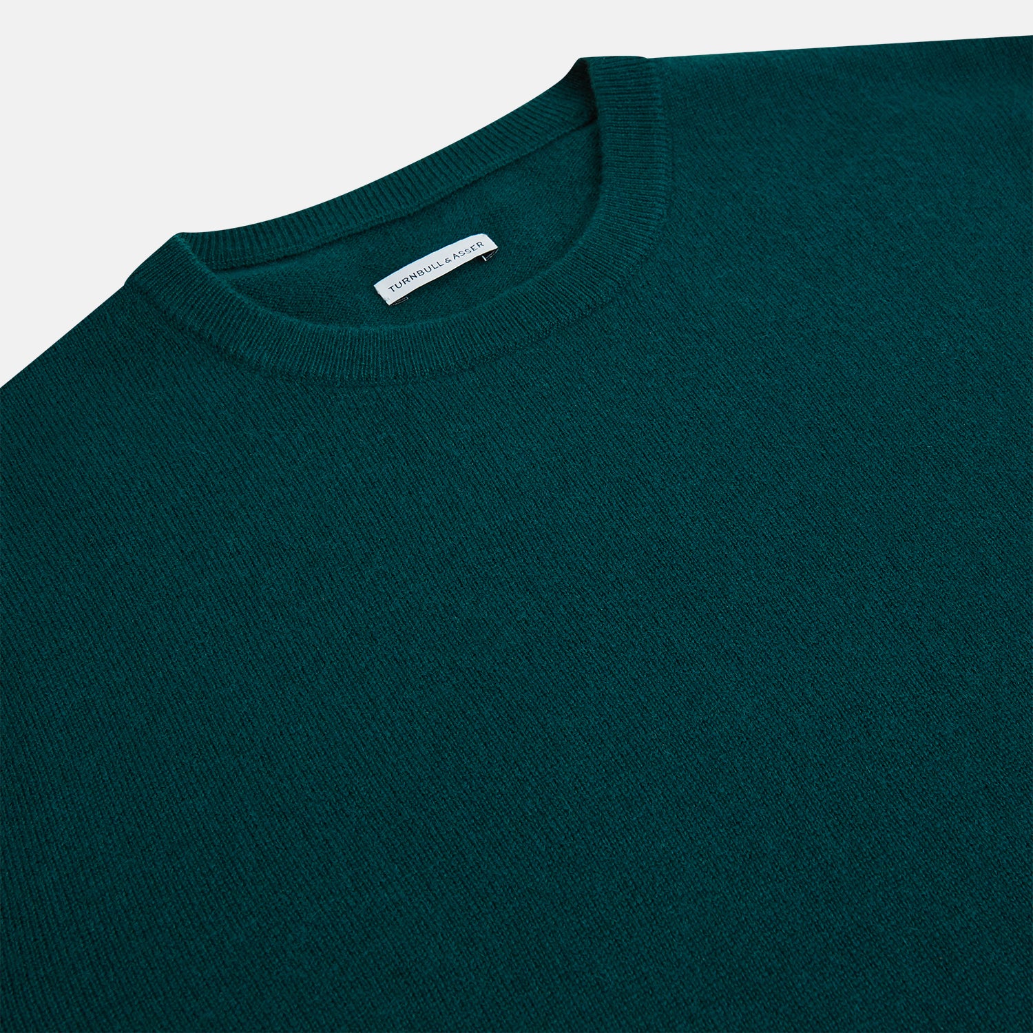 View 2 of product The Turnbull & Asser Moss Green Cashmere Round Neck Jumper, shown on a plain white background, is men's knitwear with long sleeves and a classic design featuring ribbed cuffs, neckline, and hem for timeless style.