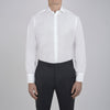View 2 of product The Sea Island Cotton Classic Fit White Shirt by Turnbull & Asser features a classic collar and front buttons, neatly folded with its label visible, displayed on a light blue background.