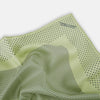 View 2 of product The Melon Green Dot Silk Pocket Square by Turnbull & Asser is handmade in England from silk, featuring small black polka dots. Shown folded with a turned-up corner, it displays both sides of the light green fabric.