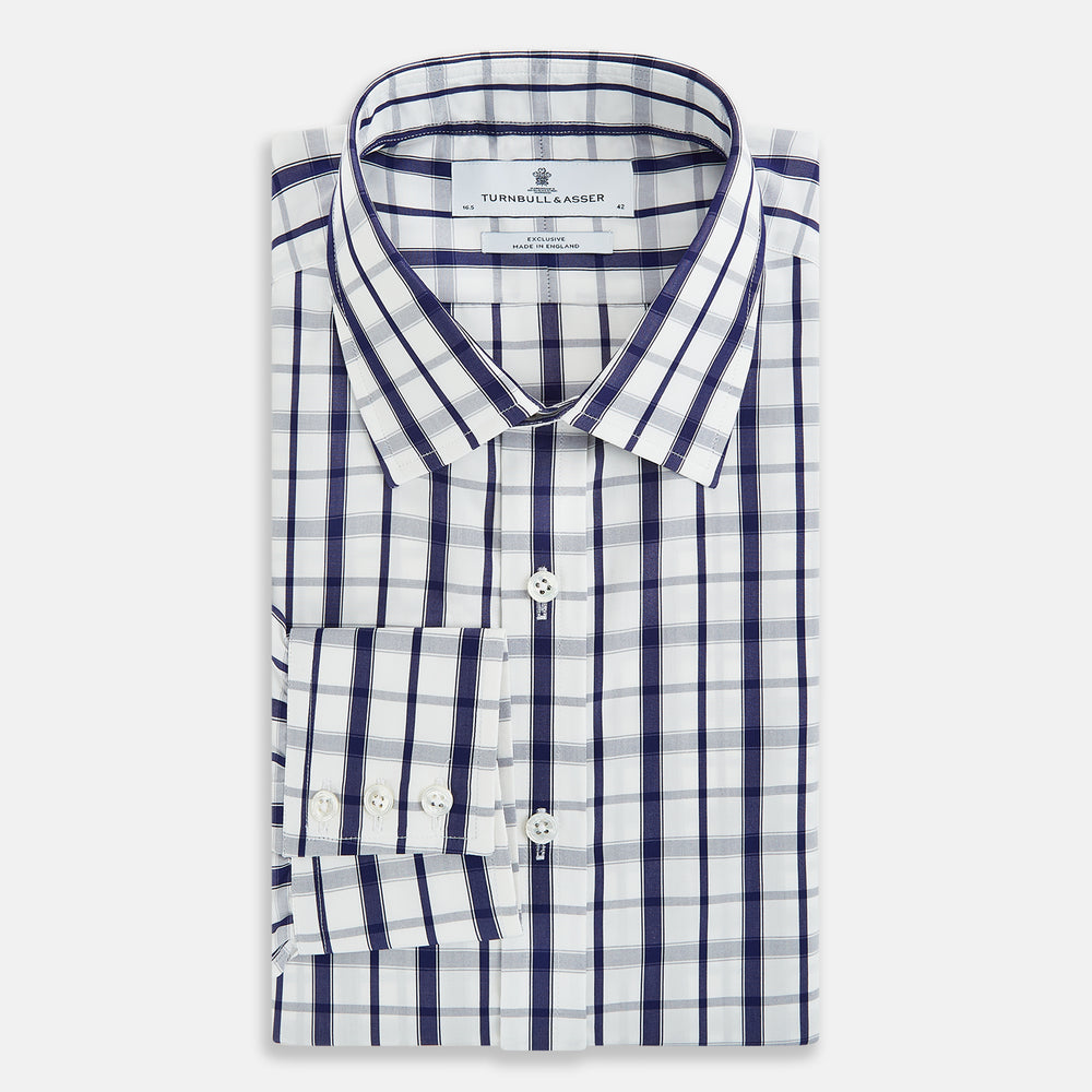 The Turnbull & Asser Navy Plaid Check Mayfair Shirt is crafted from pure cotton in white and navy checks, featuring a pointed collar and buttoned cuffs—perfect for formal looks.