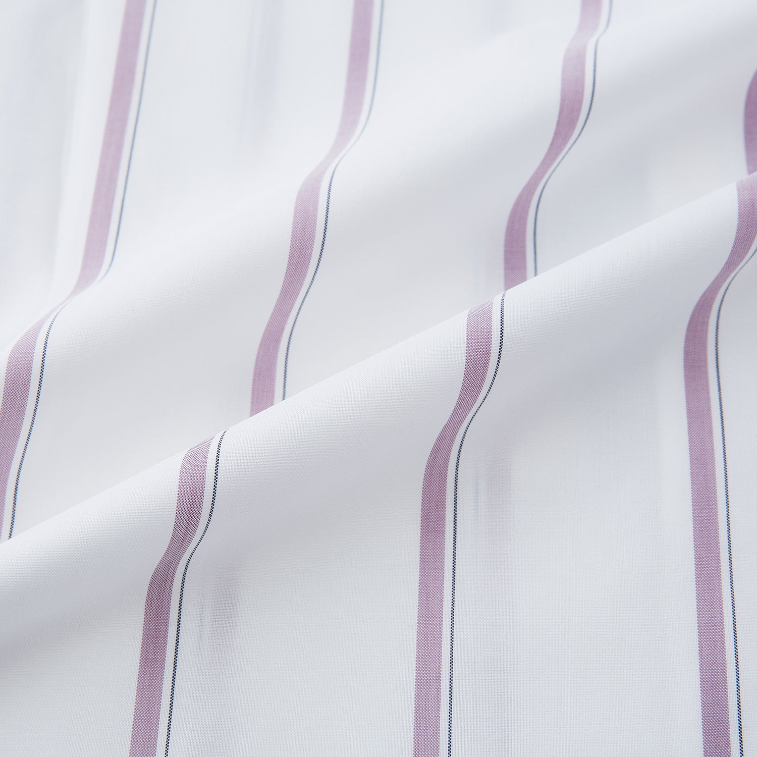 View 6 of product The Turnbull & Asser Antique Pink Track Stripe Mayfair Shirt is a white, long-sleeved Italian cotton shirt with vertical pink stripes, a spread collar, and buttoned cuffs, shown laid flat on a white background.