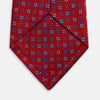 View 4 of product The Turnbull & Asser MINI SQUARE SPOT TULIP RED BLUE TIE features a vivid red base with blue and white geometric spots, making it a stylish addition to any refined ensemble.