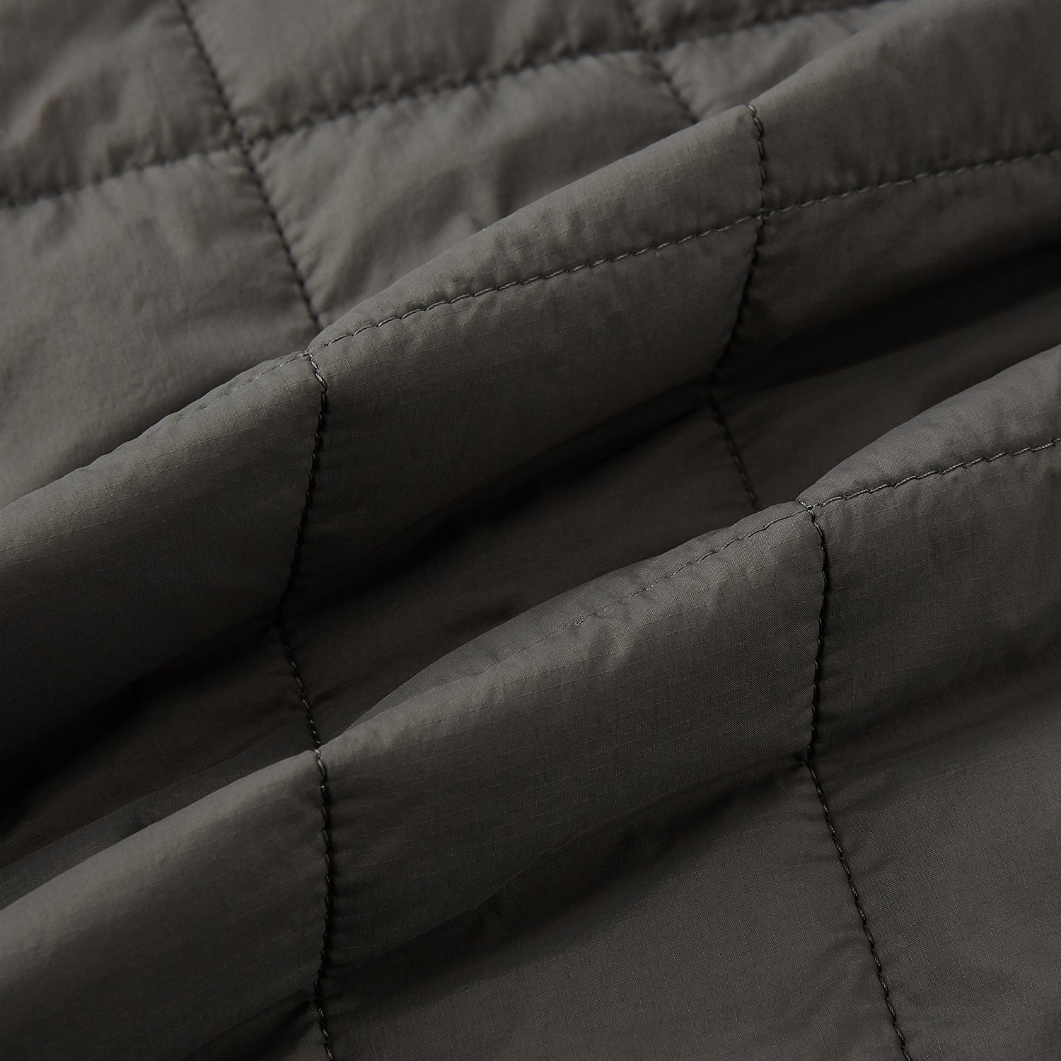 View 5 of product The Battersea Shadow Grey Quilted Jacket by Turnbull & Asser features a front zipper, buttoned cuffs, pointed collar, and multiple pockets—an ideal choice for the modern gentleman. Shown on a plain white background.