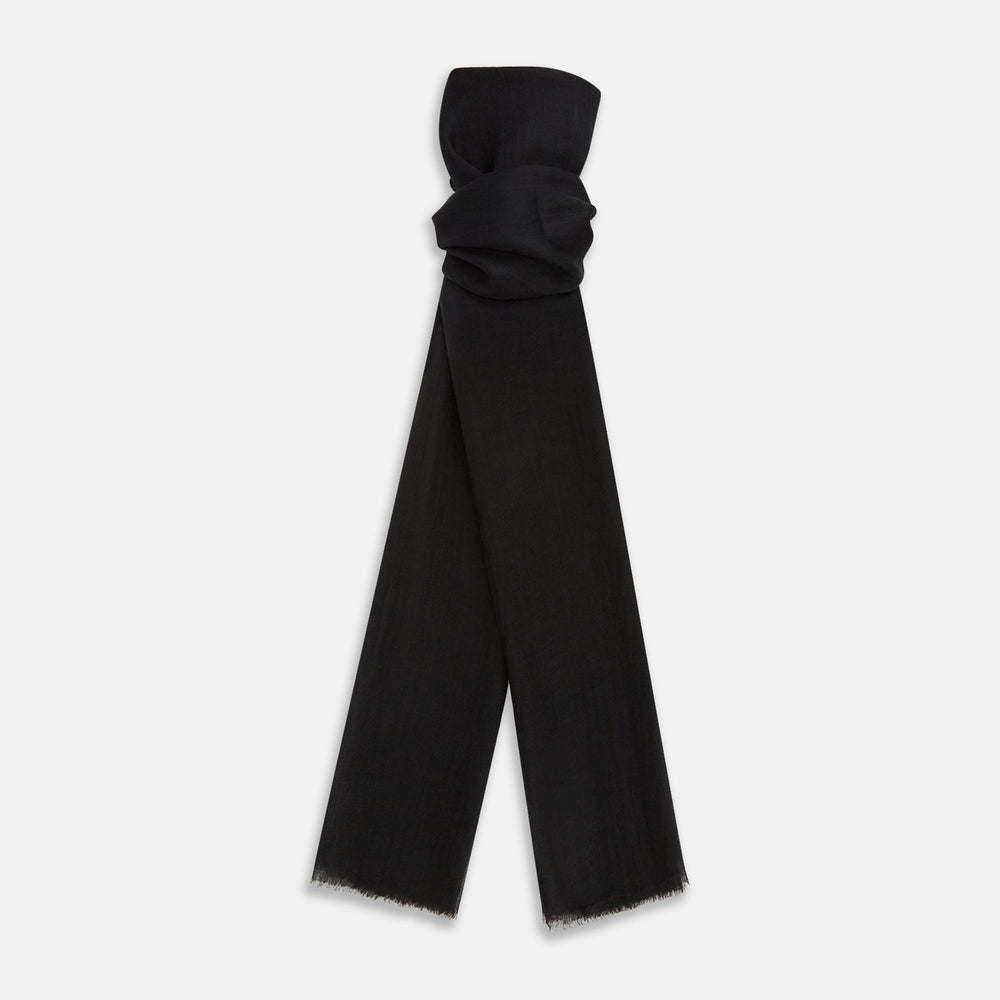 The Turnbull & Asser Charcoal Melange Cashmere Scarf features a smooth texture, subtle frayed edges, and a loosely knotted style, elegantly displayed on a white background—an ideal luxury accessory for any season.