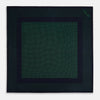View 4 of product The Turnbull & Asser Navy and Green Dot Silk Pocket Square features dense green polka dots on navy silk, a solid navy border, and a band of spaced green dots—expertly handmade with precise finishing for an elegant look.