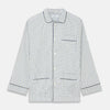 View 5 of product The Turnbull & Asser Green and Blue Check Cotton Hyde Pyjama Set for men features a long-sleeve, button-up top and pants with contrasting dark piping, shown laid flat on a white background.
