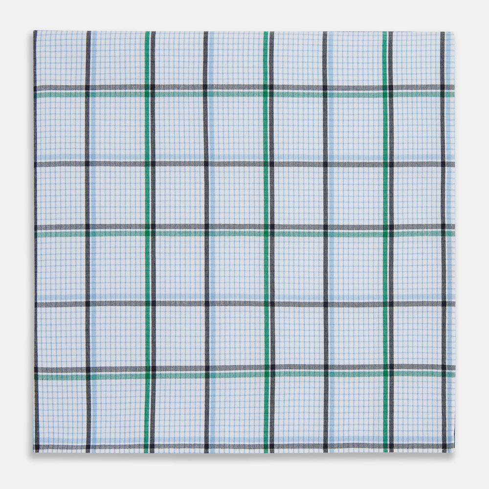 The Turnbull & Asser Hand Rolled Blue and Green Tattersall Check Handkerchief—a white cotton pocket square with blue, green, and black check pattern—is neatly displayed on a plain white background.