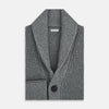 View 4 of product The Turnbull & Asser Grey Melange Cashmere Shawl Collar Cardigan features a ribbed-knit texture, five black front buttons, and two pockets, shown against a plain white background.