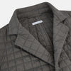 View 2 of product The Fulham Shadow Grey Single-Breasted Quilted Blazer by Turnbull & Asser features a checkered pattern, notched lapel, three front buttons, chest pocket, and two flap pockets—ideal for formal wear on a plain white background.