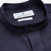 View 2 of product The Turnbull & Asser Navy Military Weekend Fit Shirt features a stand collar, black buttons, dual chest flap pockets, and 1-button cuffs in Italian cotton-wool, shown laid flat on a white background.
