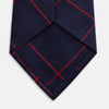 View 4 of product The Turnbull & Asser Red and Navy Window Pane Silk Tie features a refined diagonal red pattern on navy silk, making it an elegant choice for office attire.