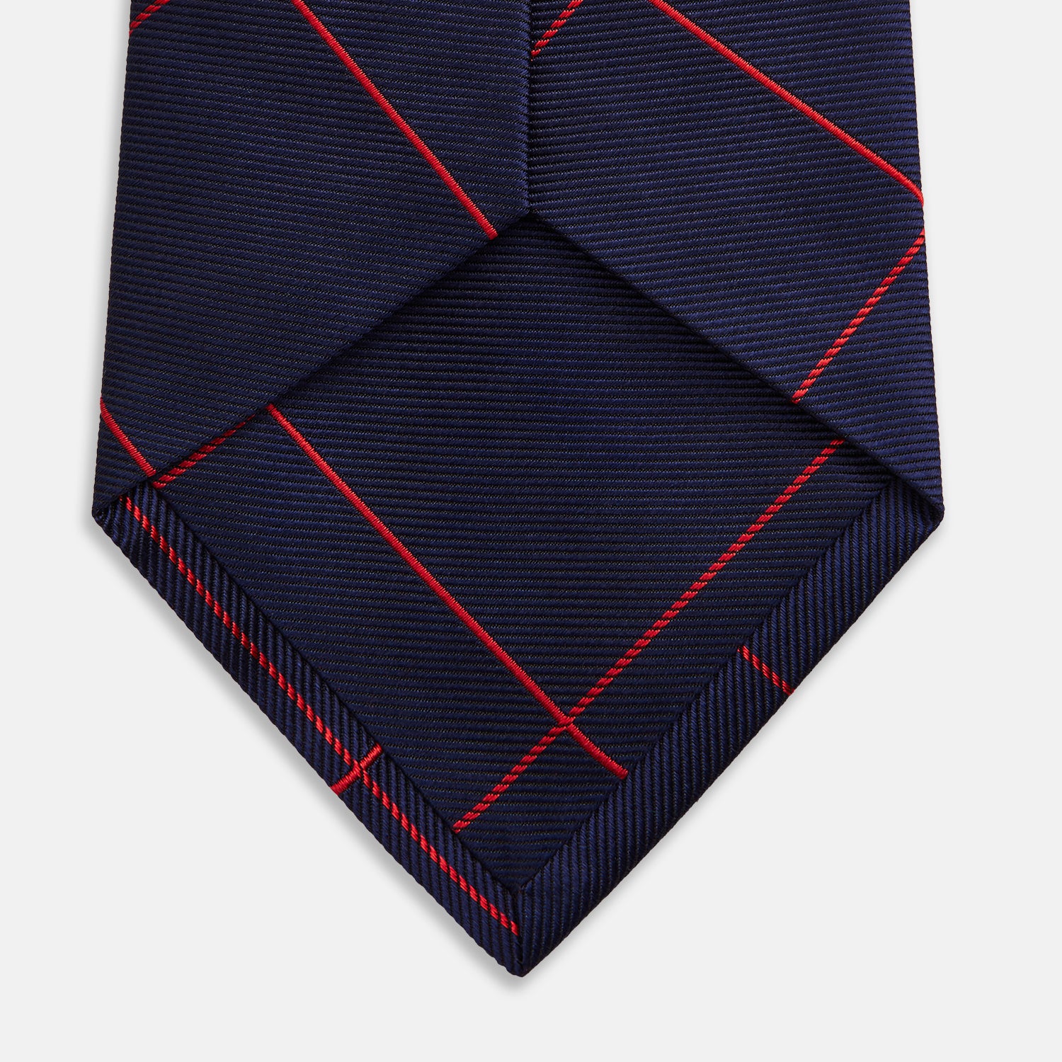 View 4 of product The Turnbull & Asser Red and Navy Window Pane Silk Tie features a refined diagonal red pattern on navy silk, making it an elegant choice for office attire.