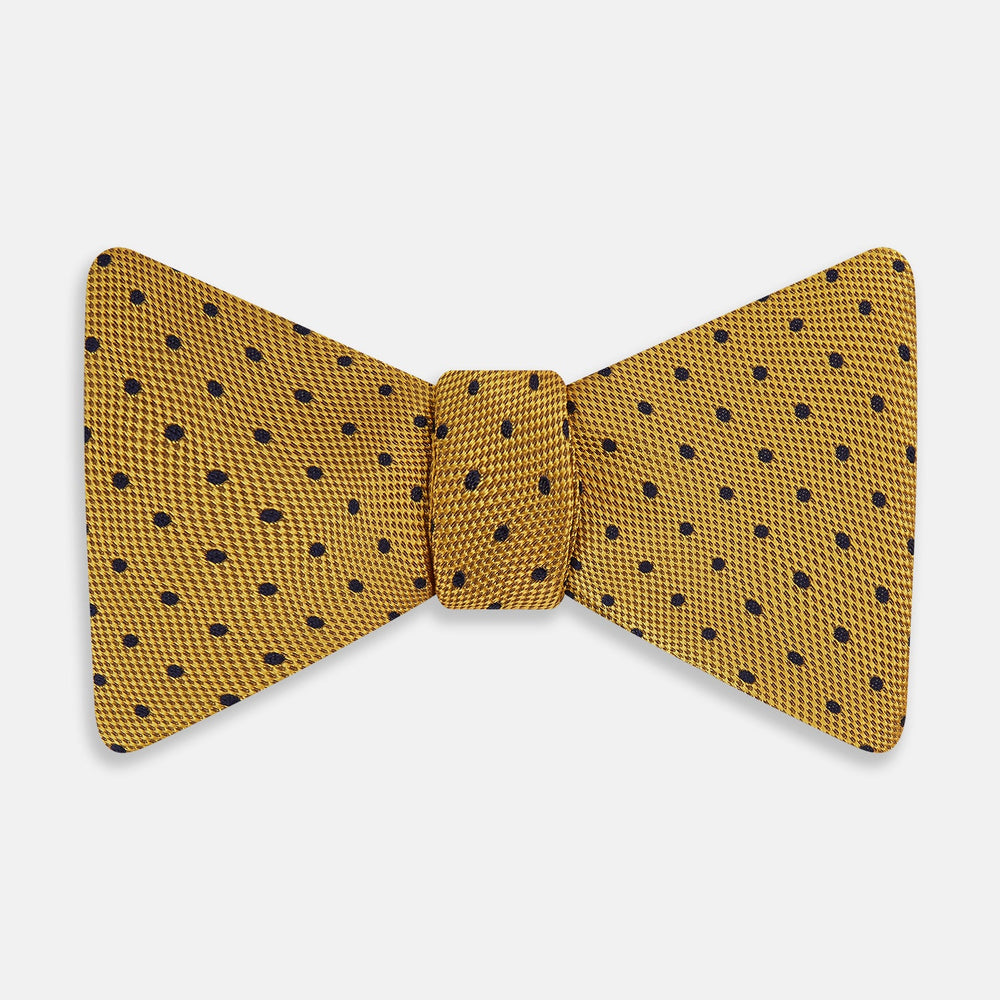 The Navy and Yellow Micro Dot Silk Bow Tie by Turnbull & Asser features a refined dot pattern—an ideal accessory for elevating sophisticated outfits.