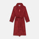 The Turnbull & Asser Burgundy Linen & Cotton Cord Gown, expertly made in England, features a shawl collar, patch pockets, and a matching fabric belt—shown here on a white background.