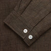 View 2 of product The Turnbull & Asser Chocolate Brown Linen Holiday Fit Fellows Shirt, featuring long sleeves, a classic collar, and white buttons, is displayed flat on a white background—ideal for effortless summer style.