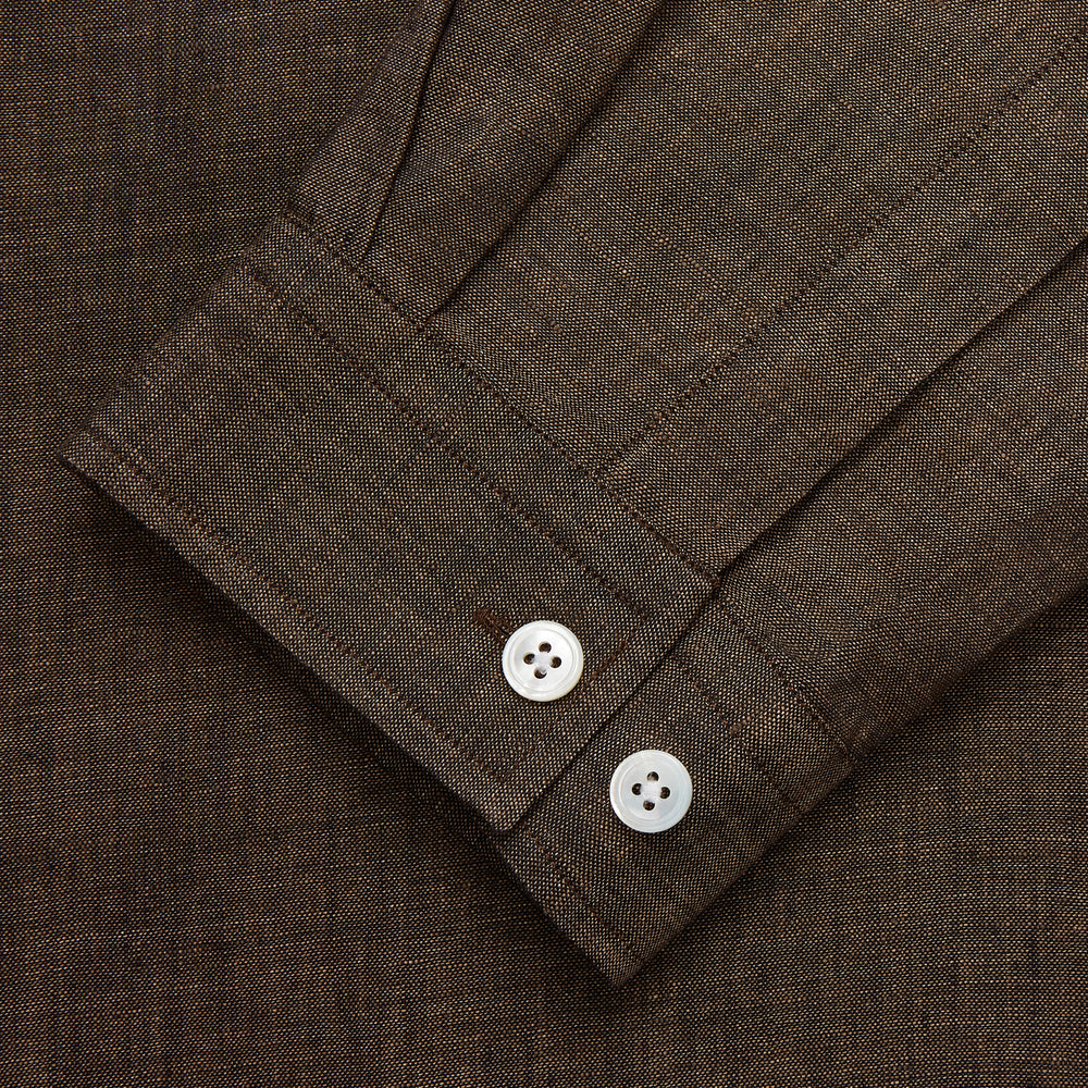 The Turnbull & Asser Chocolate Brown Linen Holiday Fit Fellows Shirt, featuring long sleeves, a classic collar, and white buttons, is displayed flat on a white background—ideal for effortless summer style.