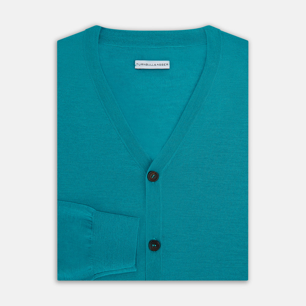 The Turnbull & Asser Turquoise Fine Merino V-Neck Cardigan features long sleeves, ribbed cuffs and hem, and black buttons, showcased against a plain white background.