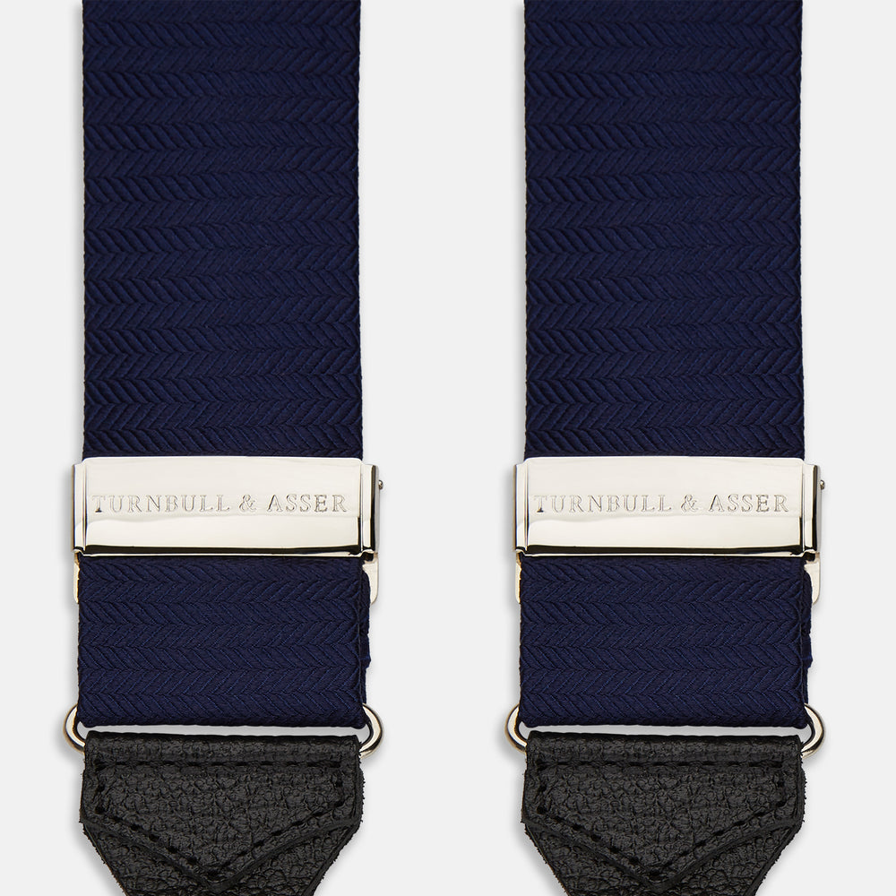 Turnbull & Asser Navy Silk Braces laid flat on a white background, featuring black leather loops, silver hardware, and an adjustable design.