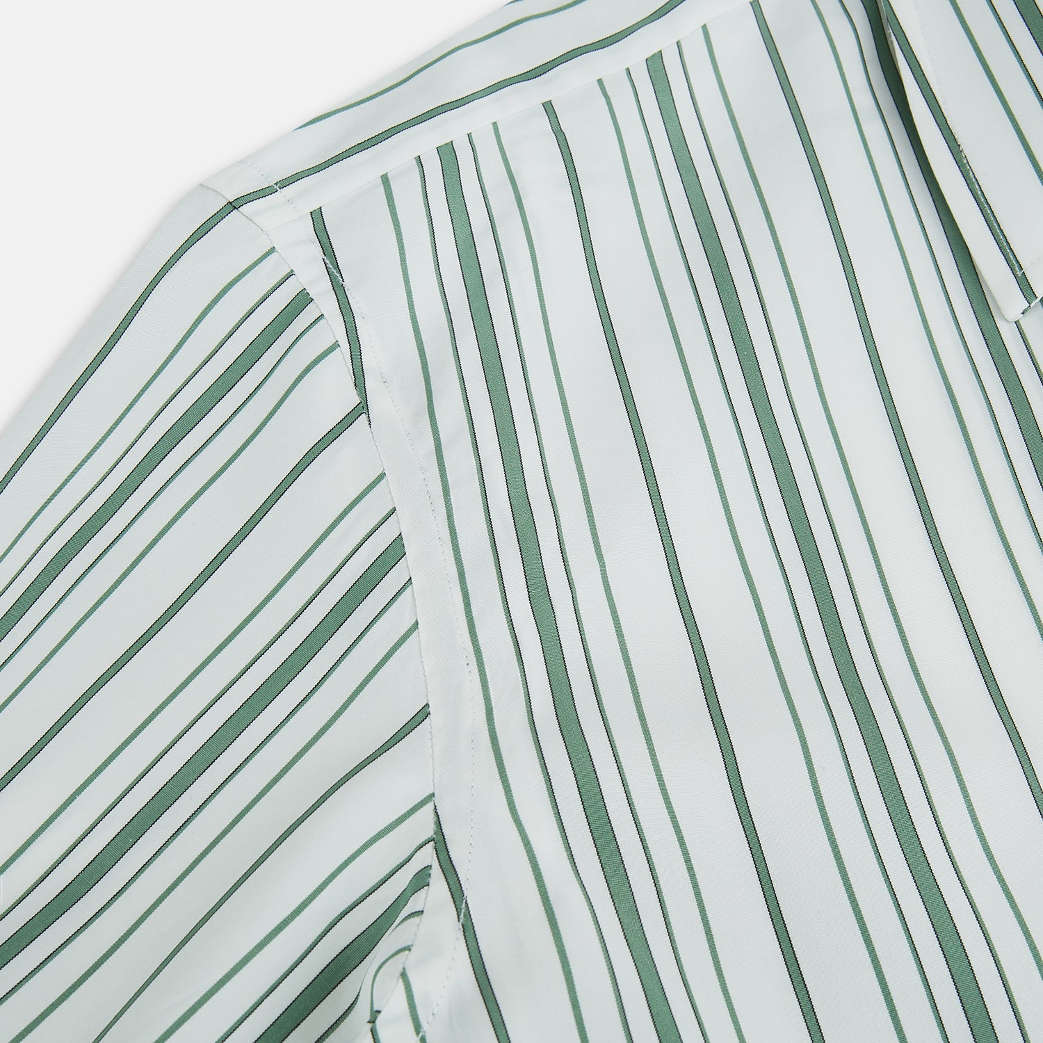 View 6 of product The SAGE GREEN MULTI STRIPE WESTMINSTER SHIRT by Turnbull & Asser features a classic collar, long sleeves, buttoned cuffs, relaxed fit, and vertical green and white stripes—embodying timeless British craftsmanship.